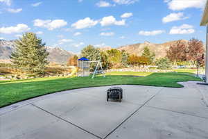 View of patio / terrace with a playground and a mountain view