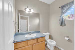 Bathroom with vanity, toilet, and tile patterned floors