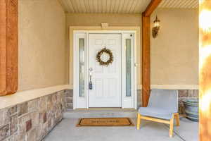 Doorway to property featuring a porch