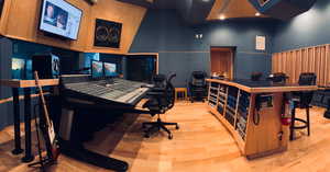 Office area with a towering ceiling and light hardwood / wood-style flooring