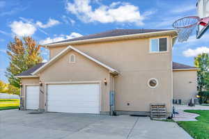 View of front of property with central AC and a garage