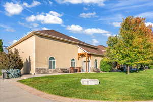 Rear view of house featuring a lawn