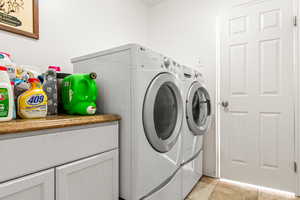 Laundry area with washing machine and clothes dryer