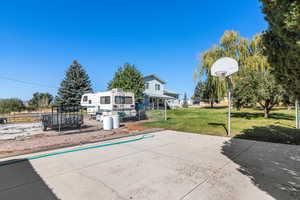 Exterior space with a front yard and basketball court