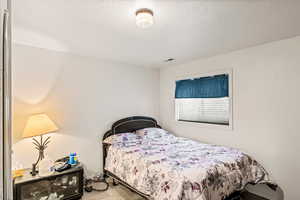 Bedroom featuring a textured ceiling and carpet flooring