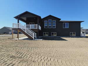 Back of house with a wooden deck