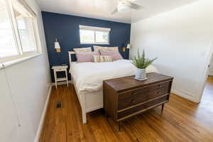 Bedroom with hardwood / wood-style floors and ceiling fan