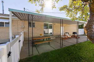 Rear view of house featuring a patio