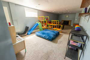 Carpeted bedroom with a brick fireplace