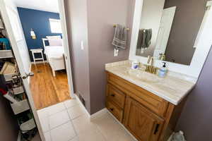 Bathroom featuring tile patterned floors and vanity