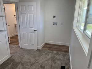 Laundry area featuring washer hookup, dark hardwood / wood-style floors, and electric dryer hookup