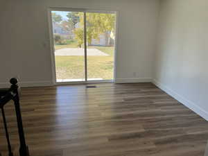 Spare room with dark hardwood / wood-style flooring