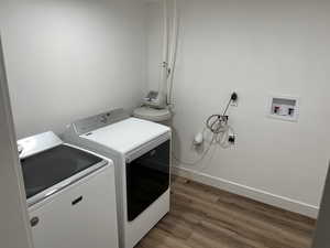 Laundry room with washing machine and dryer and dark hardwood / wood-style flooring