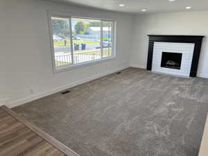 Unfurnished living room featuring wood-type flooring