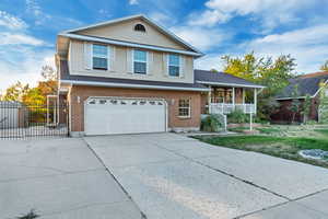 View of front of property featuring a garage and a porch