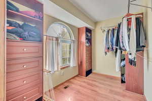 Walk in closet featuring light wood-type flooring