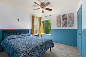 Bedroom featuring ceiling fan and carpet flooring