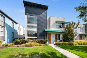 Modern home featuring a front lawn