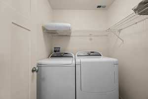 Laundry area with washing machine and clothes dryer