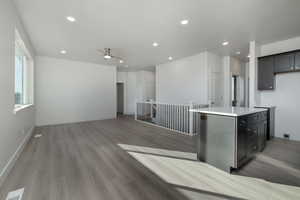 Kitchen with a center island, ceiling fan, and light hardwood / wood-style flooring