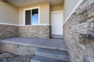 Property entrance featuring a patio area