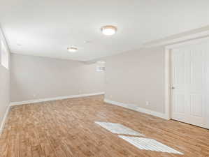 Basement featuring light wood-type flooring