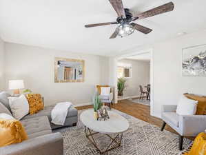 Living room featuring light hardwood / wood-style floors and ceiling fan