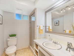 Bathroom with vanity, toilet, and an enclosed shower