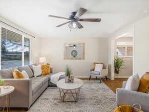 Living room featuring light wood-type flooring and ceiling fan