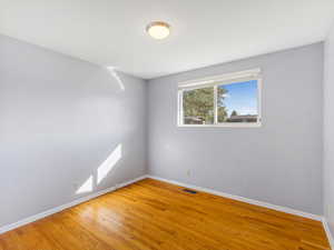 Unfurnished room with hardwood / wood-style flooring