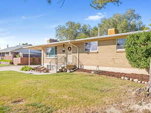 Single story home with a front yard