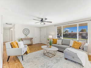 Living room featuring wood-type flooring and ceiling fan