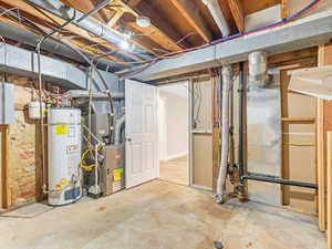 Basement featuring gas water heater and heating unit