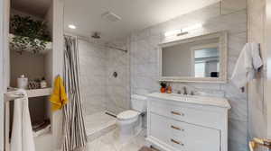 Basement bathroom with tile walls.