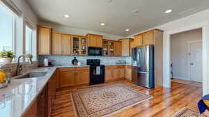 Kitchen featuring light stone countertops and modern backsplash.