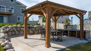 View of patio / terrace with gazebo and pizza oven.