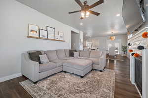 Living room featuring dark hardwood / wood-style floors and ceiling fan