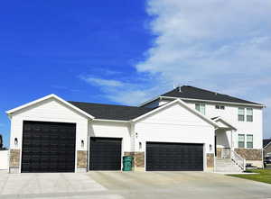 View of front facade featuring a garage