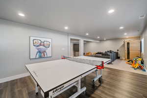 Recreation room with dark hardwood / wood-style floors