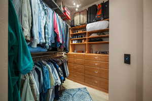 Spacious closet with light wood-type flooring