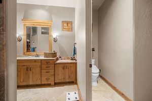 Bathroom with vanity, toilet, and tile patterned floors