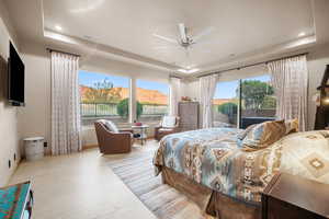 Bedroom with light hardwood / wood-style floors, a mountain view, multiple windows, and ceiling fan