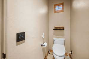 Bathroom featuring tile patterned floors and toilet