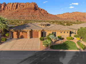 View of front of house with a garage and a mountain view