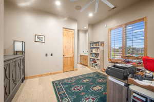 Bedroom/Office area featuring light hardwood / wood-style floors and ceiling fan