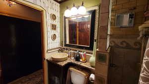 Bathroom featuring crown molding, vanity, and toilet