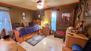 Bedroom with ornamental molding and ceiling fan