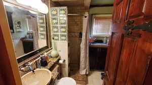 Master Bathroom with tile patterned floors, vanity, toilet, and a shower