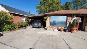 View of side of home with a carport