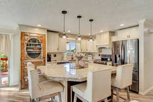 Kitchen with oversized island. Pantry door is a 1902 parlor door from Salt Lake City.